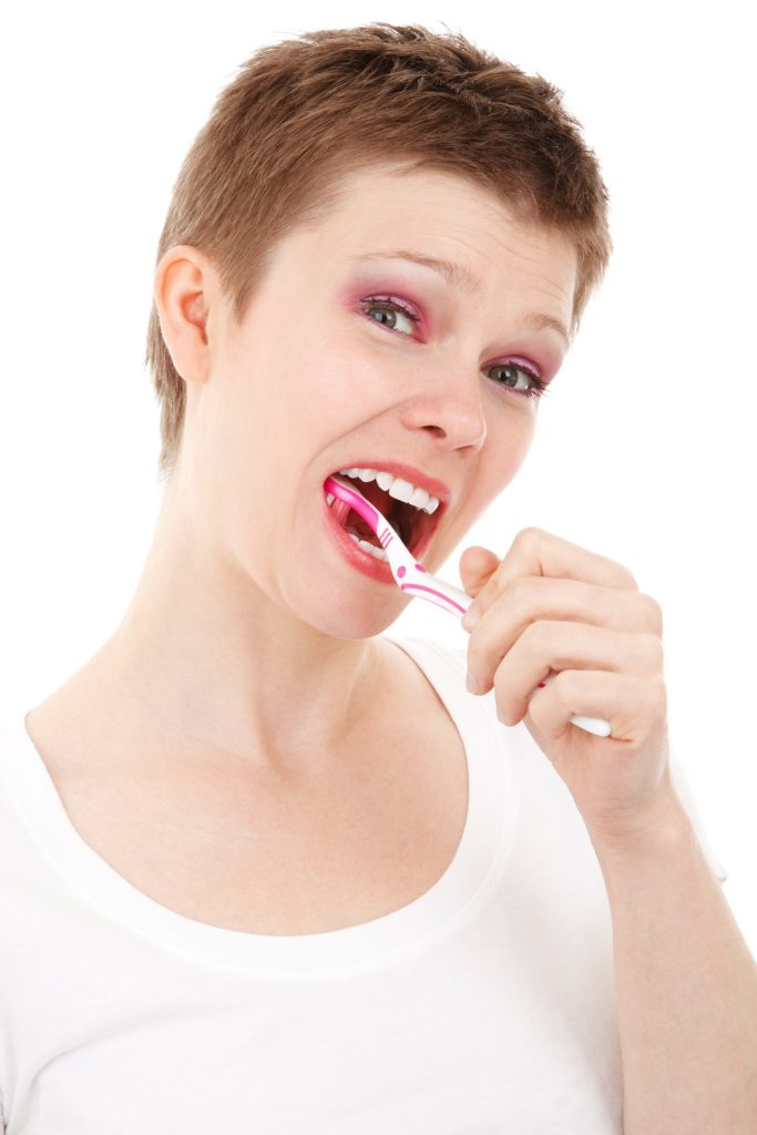 lady brushing their teeth