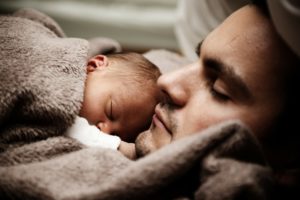 baby sleeping on a male