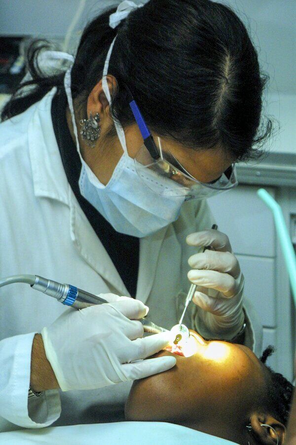 Dentist performing root canal treatment