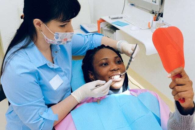 girl smiling on dentists chair