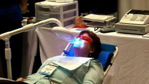Cosmetic dental procedure on teeth whitening chair